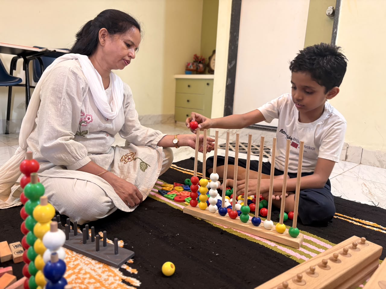 Special educator working with a child on developmental learning activity