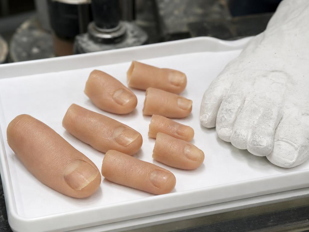 Custom silicone toe prostheses beside a plaster foot mould