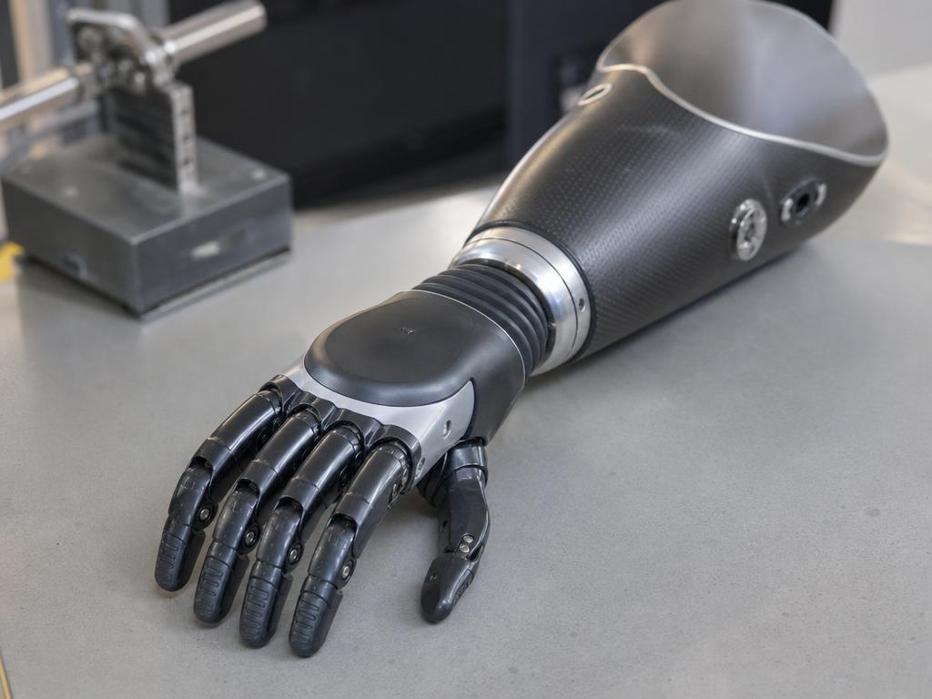 Modern myoelectric prosthetic hand with forearm socket on a clinic workbench